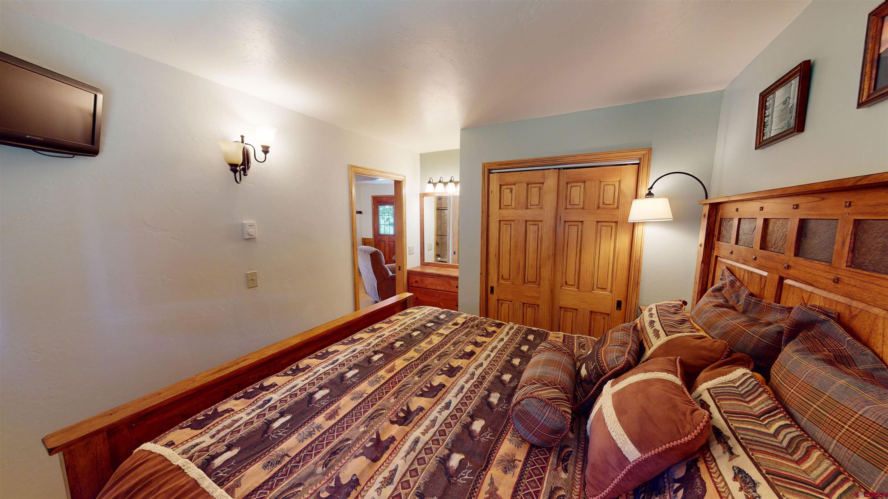 18 Crystal Road, Unit 3B Crested Butte, CO 81225 - Photo 14 of 20 a bedroom with a bed and flat screen tv