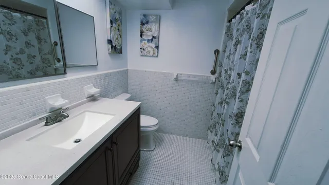 a bedroom with a bed and flat screen tv