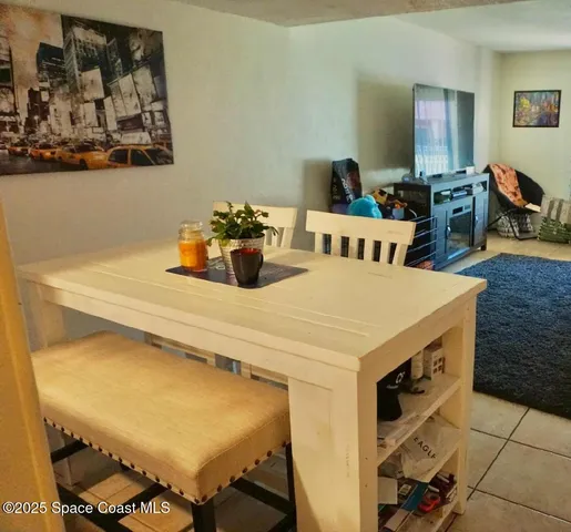 a view of a dining room with furniture and a chandelier