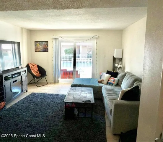 a view of a kitchen with a sink and a refrigerator