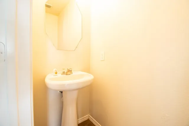 a bathroom with a sink a mirror and a vanity