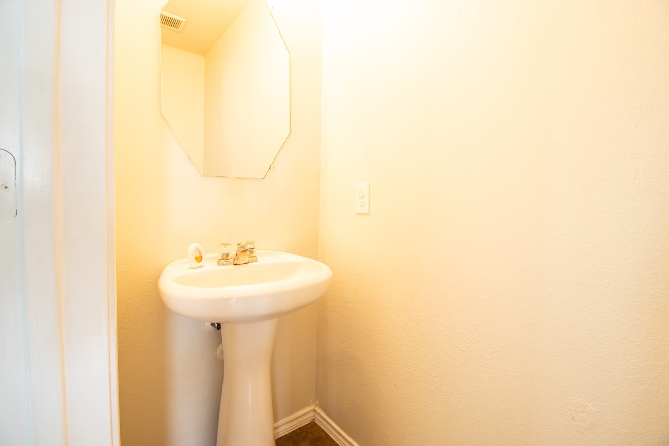 21218 Branchport Drive Houston, TX 77095 - Photo 17 of 18 a bathroom with a sink a mirror and a vanity