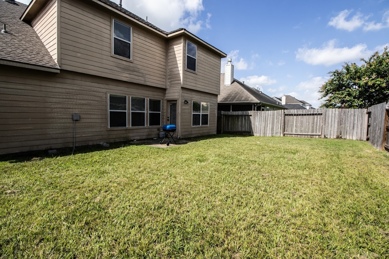 21218 Branchport Drive Houston, TX 77095 - Photo 18 of 18 a view of a house with a yard and wooden fence