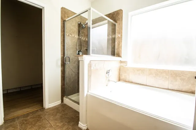 a bathroom with a bathtub and a shower