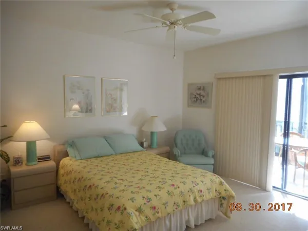 a bedroom with a bed and a lamp