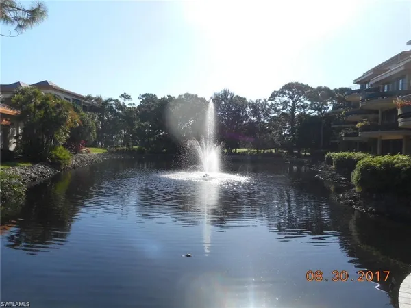 a view of river covered by trees and buildings
