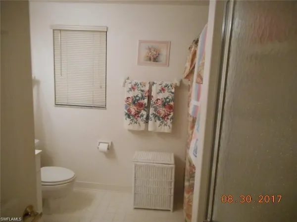 a white toilet sitting next to a bathroom sink