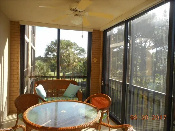 a dining room with furniture a chandelier and wooden floor