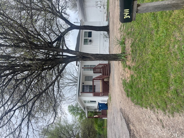 View of front facade featuring a front yard and driveway