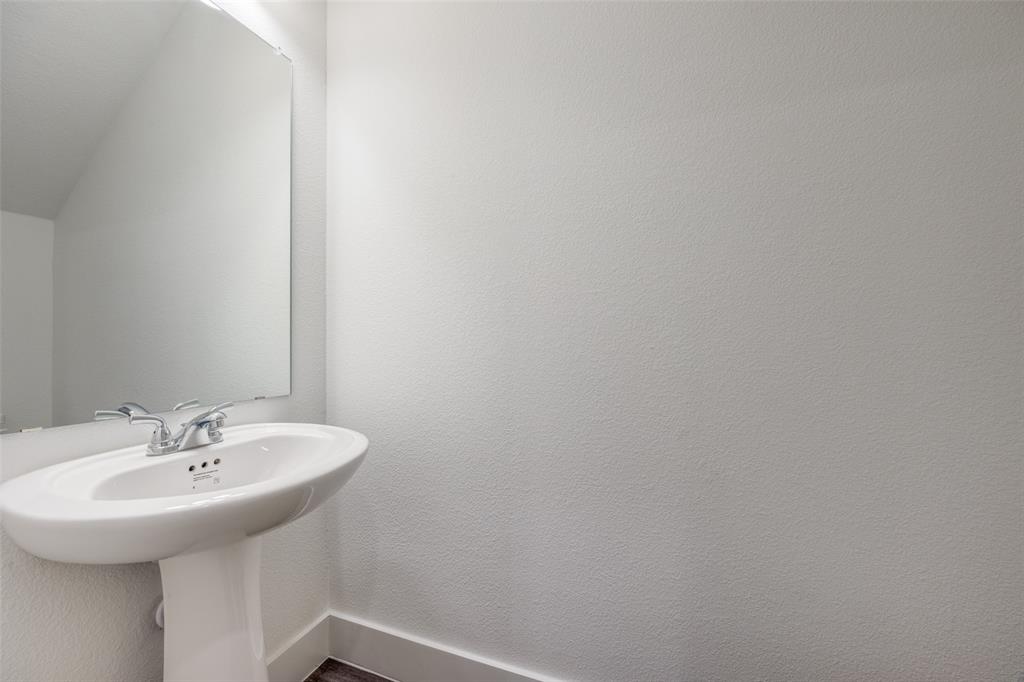 412 East 7th Street, Unit 2 Bonham, TX 75418 - Photo 5 of 12 a bathroom with a sink and a mirror