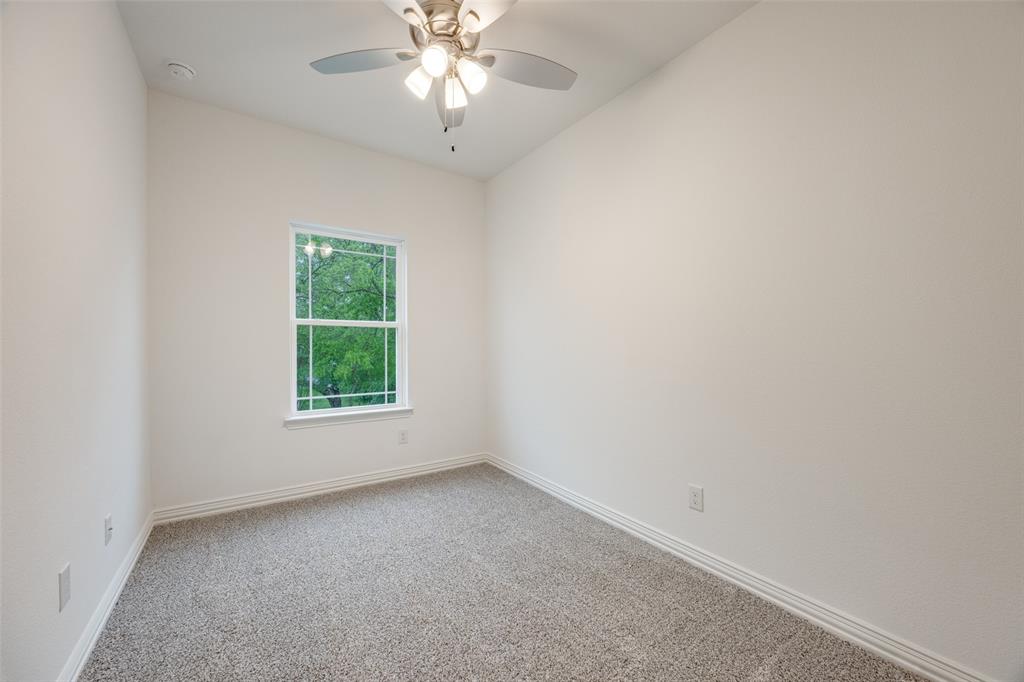 412 East 7th Street, Unit 2 Bonham, TX 75418 - Photo 9 of 12 an empty room with a window