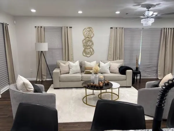a living room with furniture and wooden floor