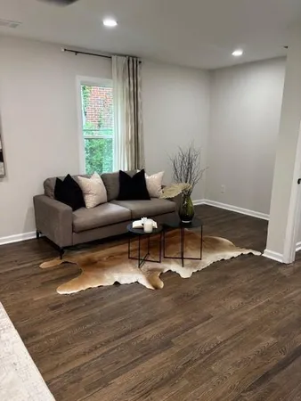 a living room with furniture and wooden floor