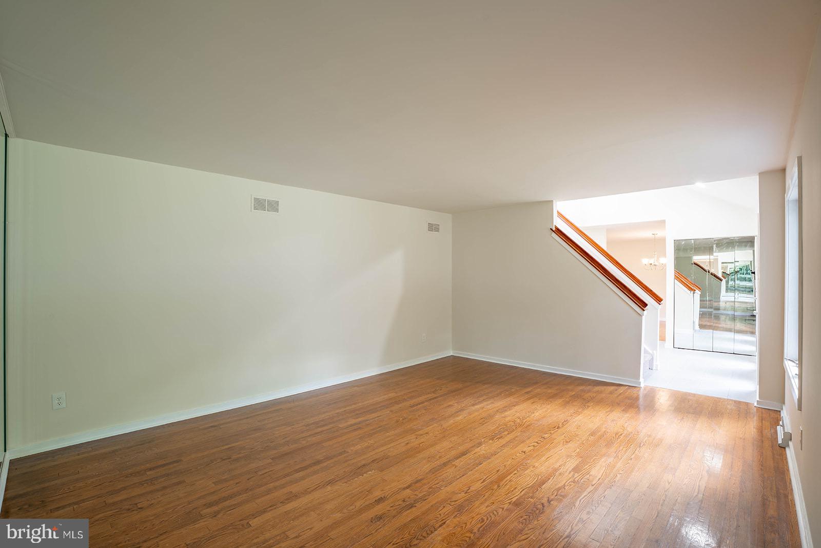 491 Kings Road Yardley, PA 19067 - Photo 11 of 52 a view of an empty room with wooden floor and a window