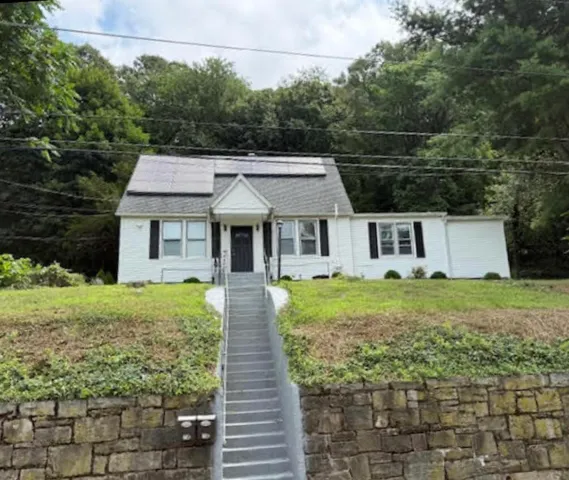 a front view of a house with garden
