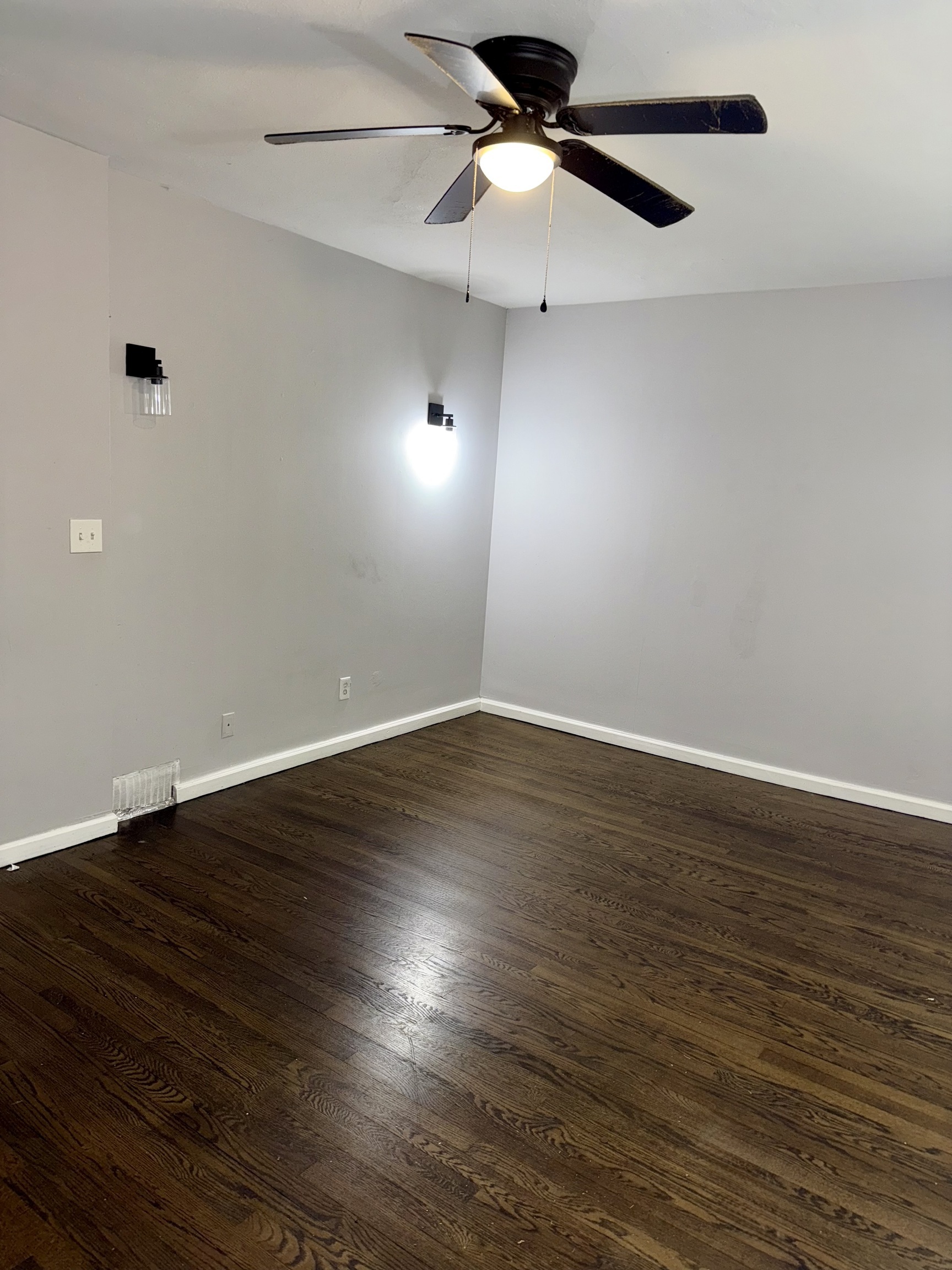 74 Mt Pleasant Street, Unit 1 Derby, CT 06418 - Photo 2 of 11 an empty room with wooden floor fan and windows