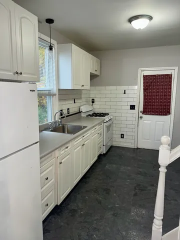 a kitchen with cabinets a sink and appliances