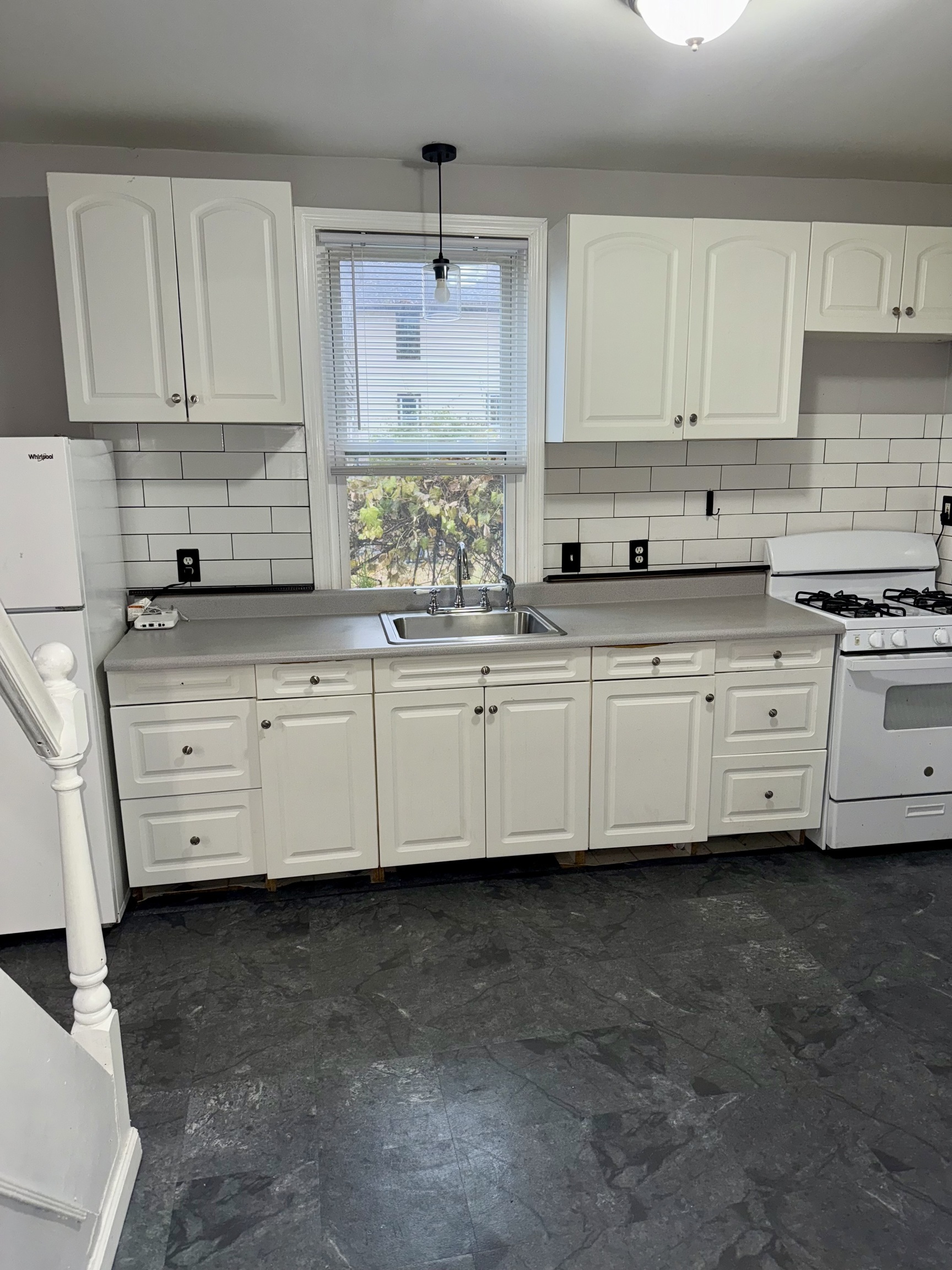 74 Mt Pleasant Street, Unit 1 Derby, CT 06418 - Photo 5 of 11 a kitchen with granite countertop a sink a stove and cabinets