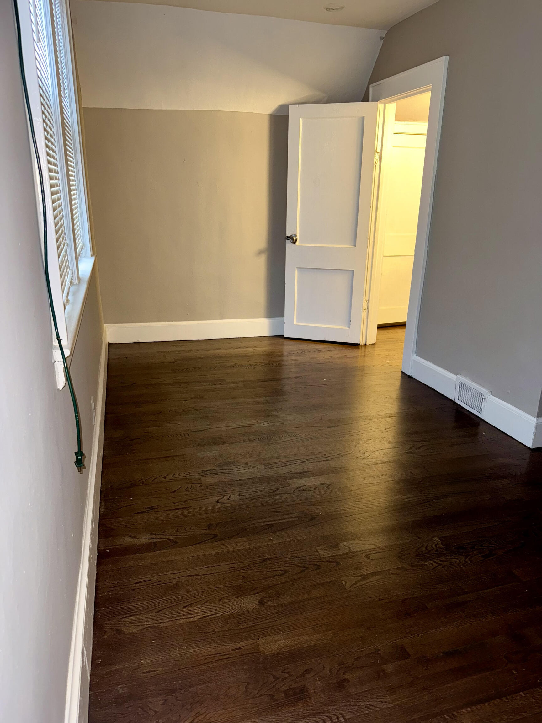 74 Mt Pleasant Street, Unit 1 Derby, CT 06418 - Photo 9 of 11 a view of an empty room with wooden floor and stairs