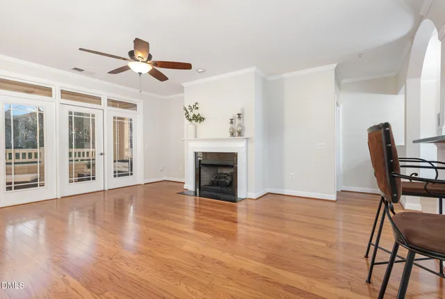 a view of a livingroom with a fireplace wooden floor and a window