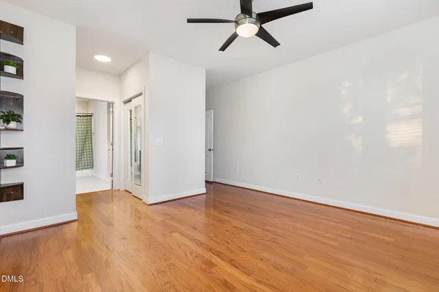 a view of a room with wooden floor and white walls