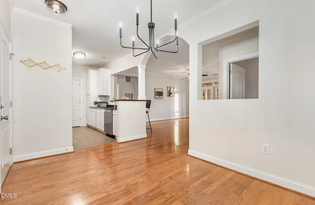 a view of a kitchen with wooden floor and a refrigerator