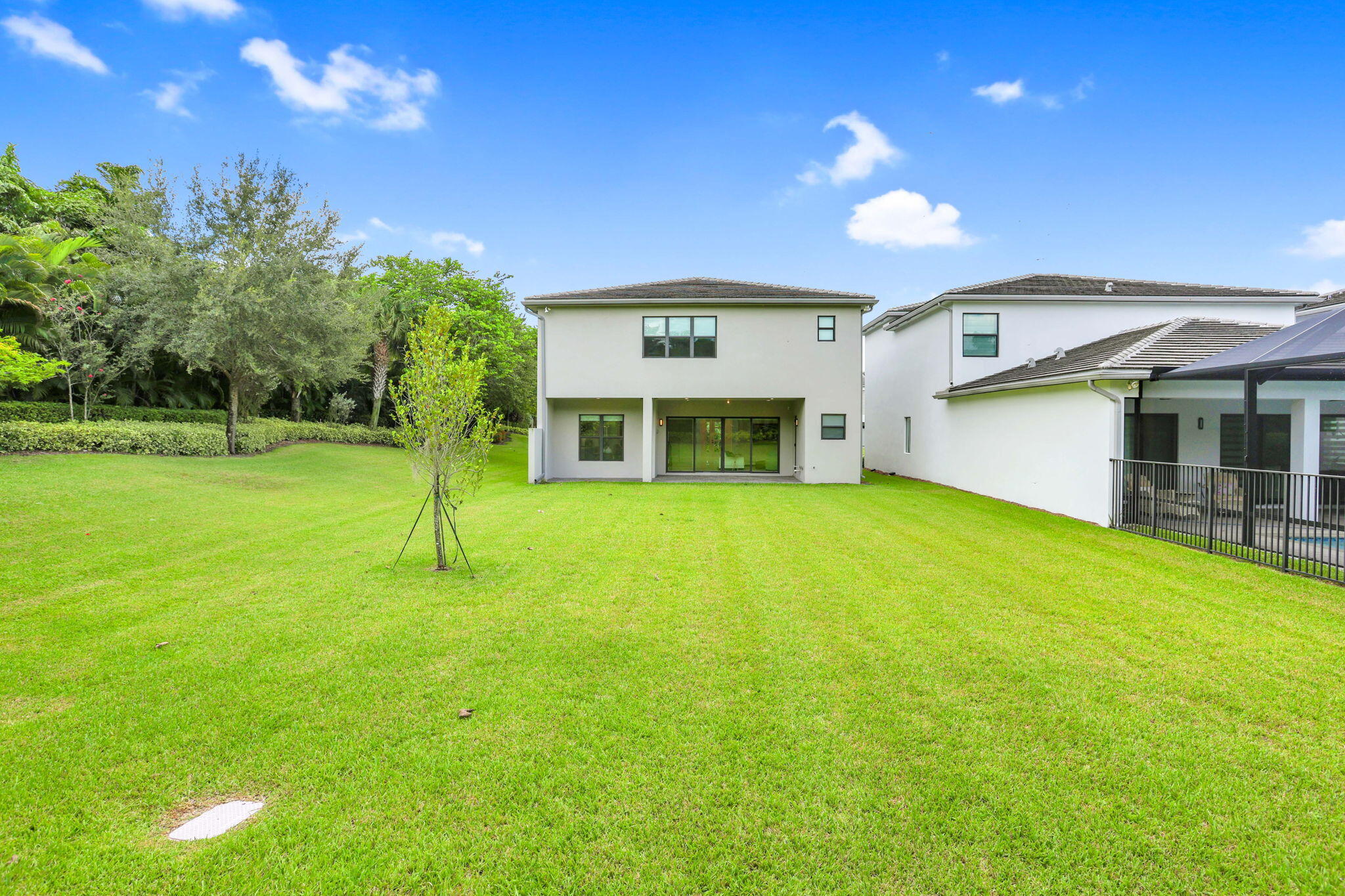 8115 Laurel Falls Drive Boca Raton, FL 33496 - Photo 27 of 74 a view of an house with backyard space and swimming pool