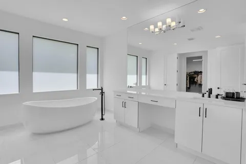 a bathroom with a sink vanity mirror and toilet