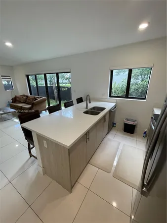 a kitchen with a stove and white cabinets