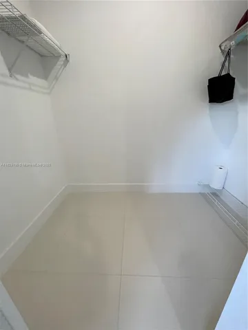 a bedroom with a bed and a night stand