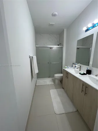 a bathroom with a sink a toilet and mirror