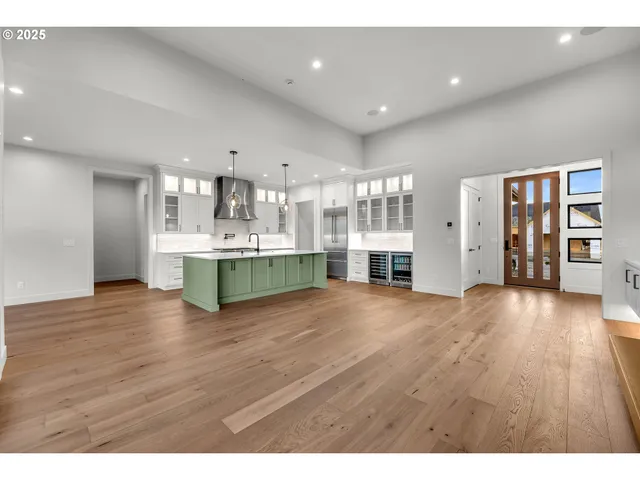 a view of kitchen and hall with wooden floor