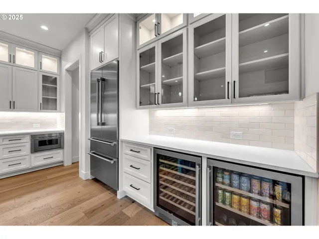 a kitchen with stainless steel appliances kitchen island granite countertop a refrigerator and cabinets