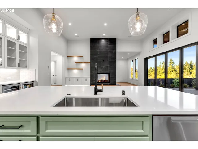 a kitchen with kitchen island a sink and a large window