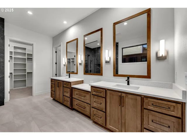 a bathroom with a double vanity sink and a large mirror
