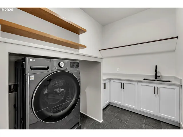 a kitchen with sink and cabinets