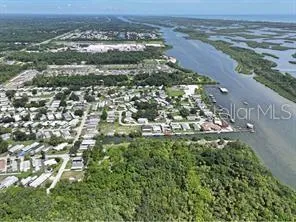 an aerial view of a houses with a yard