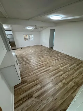 a view of a room with a ceiling fan