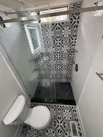 a bathroom with a toilet and a shower