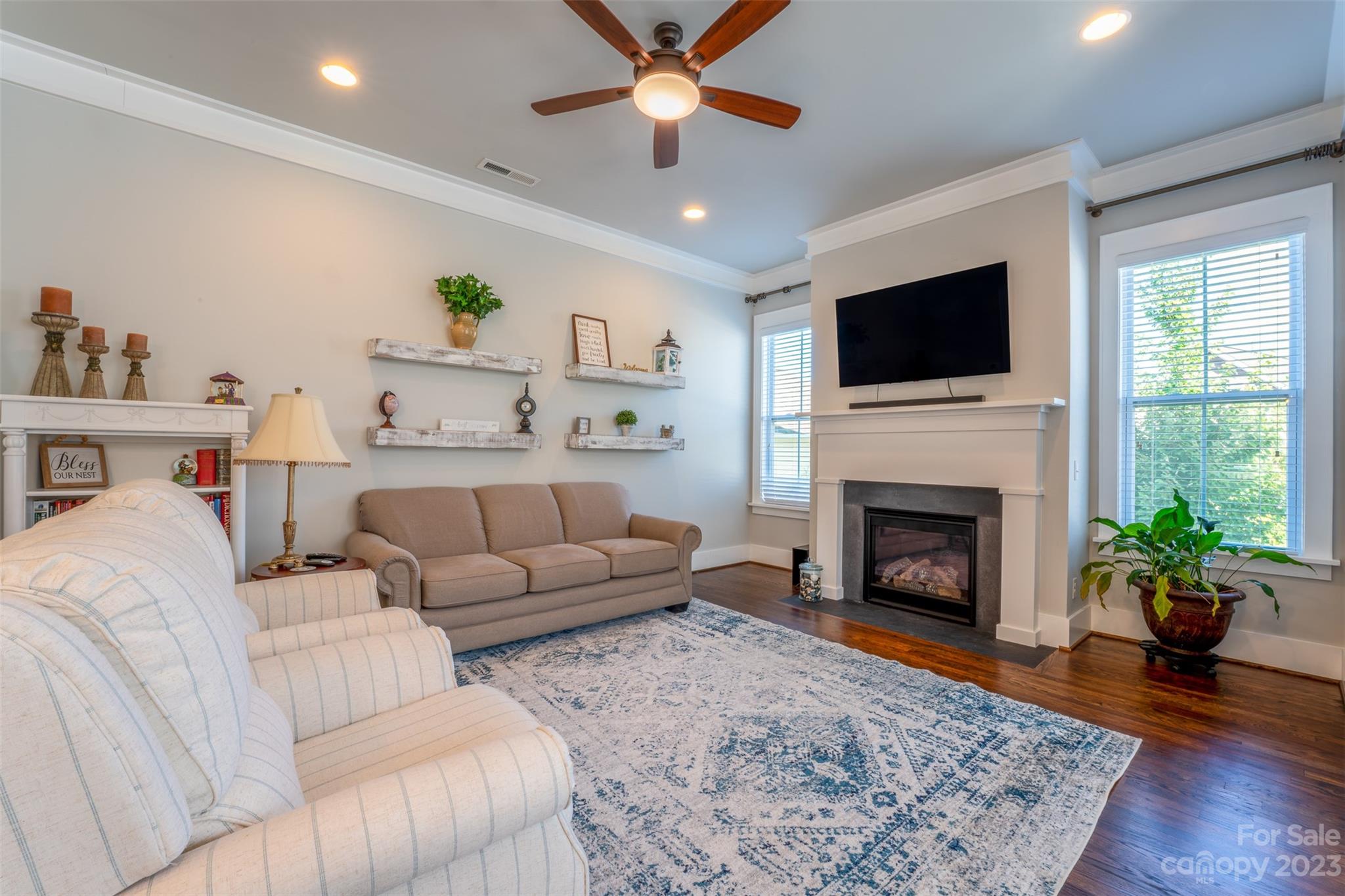 724 Bluff Loop Road Rock Hill, SC 29730 - Photo 11 of 45 a living room with furniture a fireplace and a flat screen tv