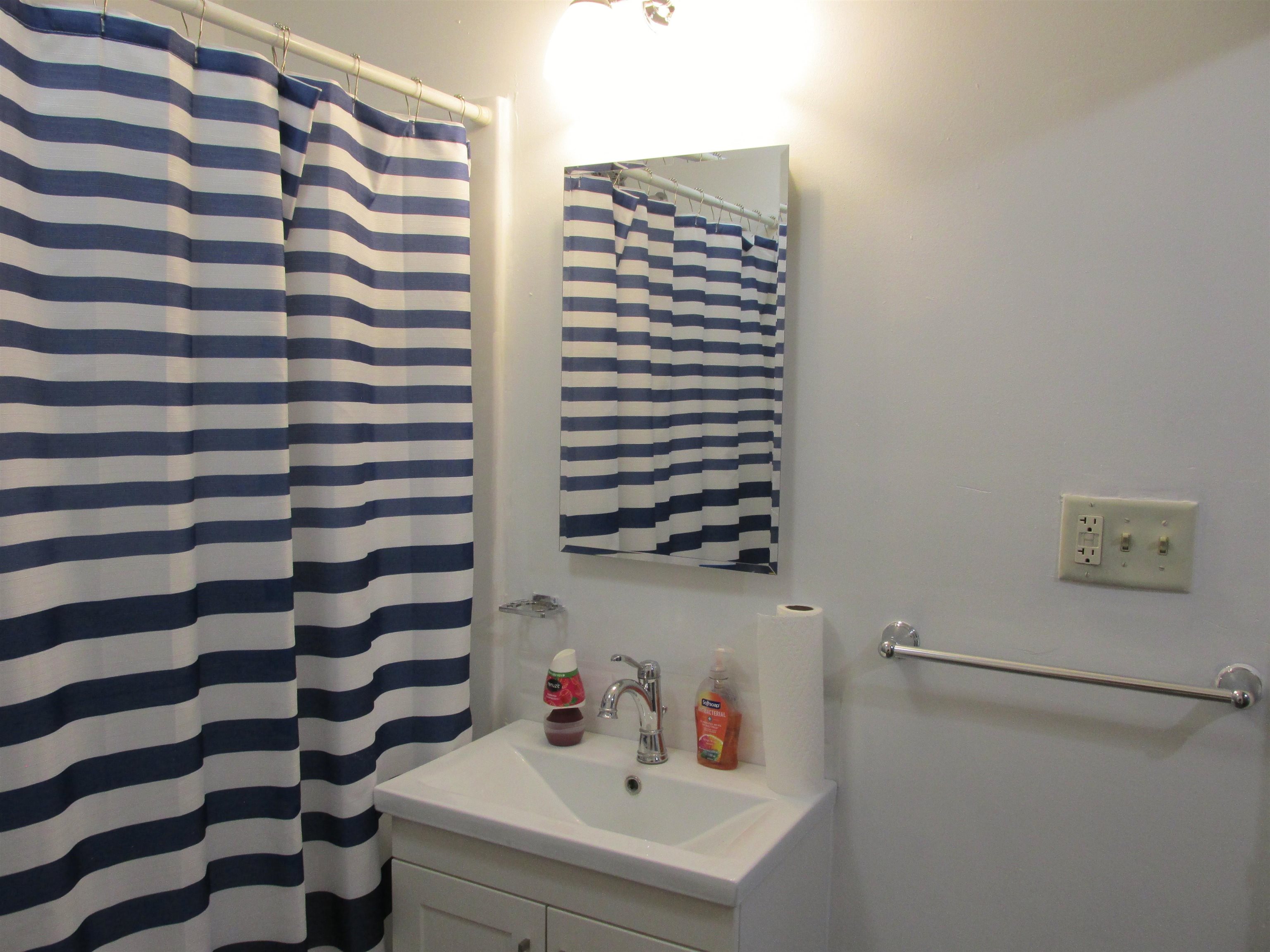 926 West 2nd Street Byron, IL 61010 - Photo 13 of 20 a bathroom with a sink and a mirror