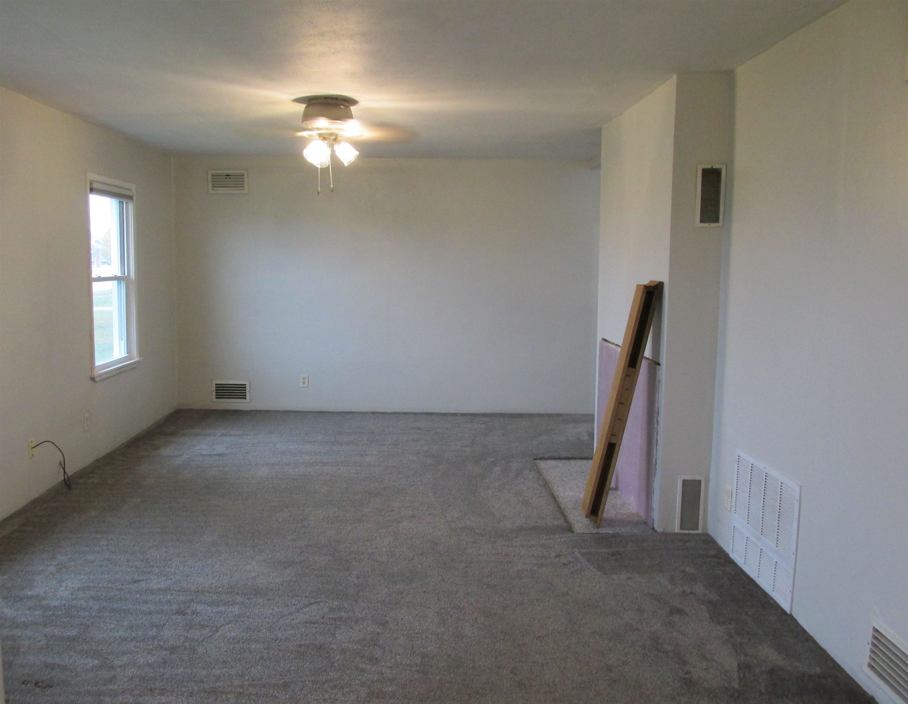926 West 2nd Street Byron, IL 61010 - Photo 2 of 20 a view of a livingroom with a staircase