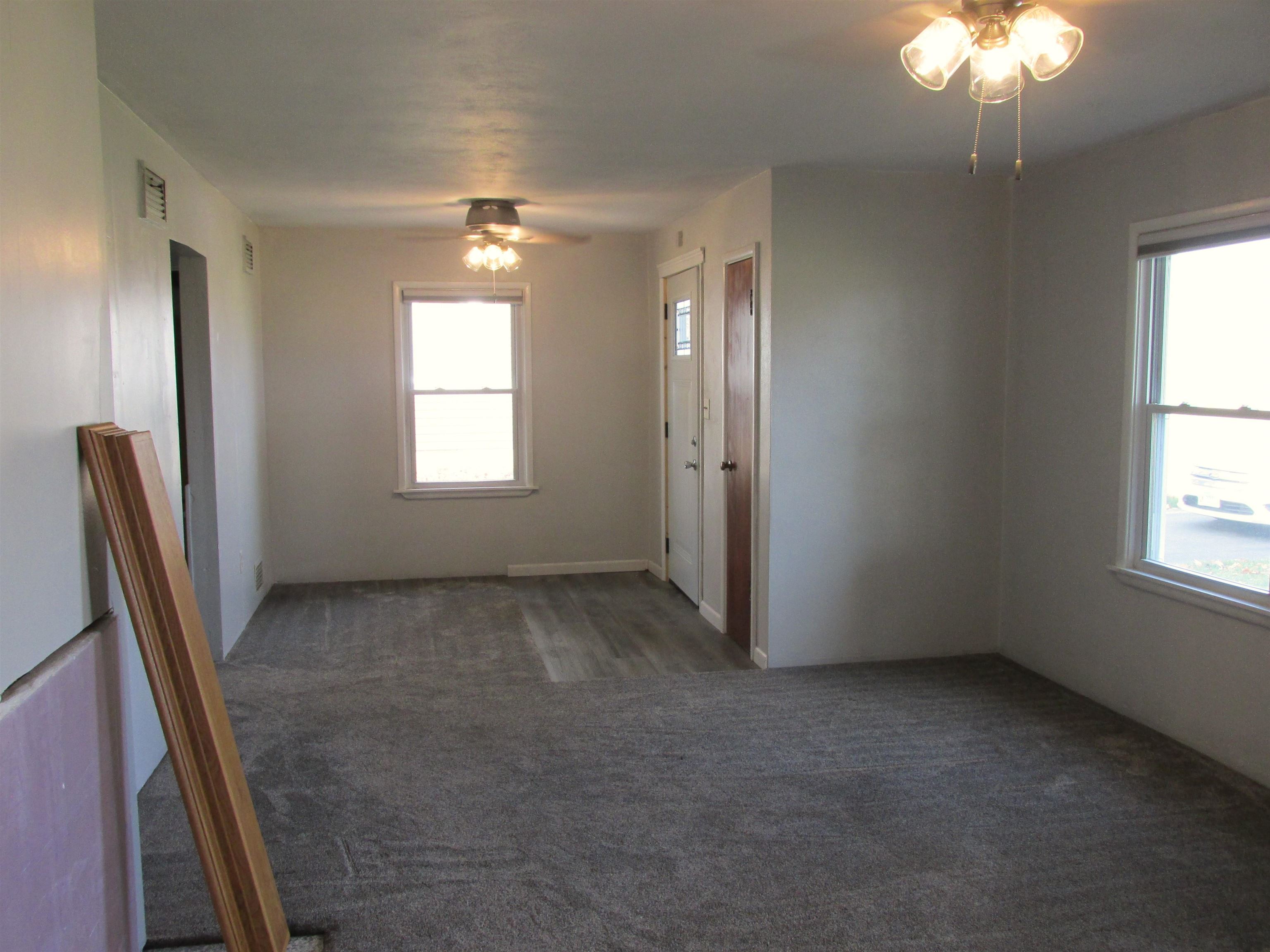 926 West 2nd Street Byron, IL 61010 - Photo 3 of 20 an empty room with windows and entrance