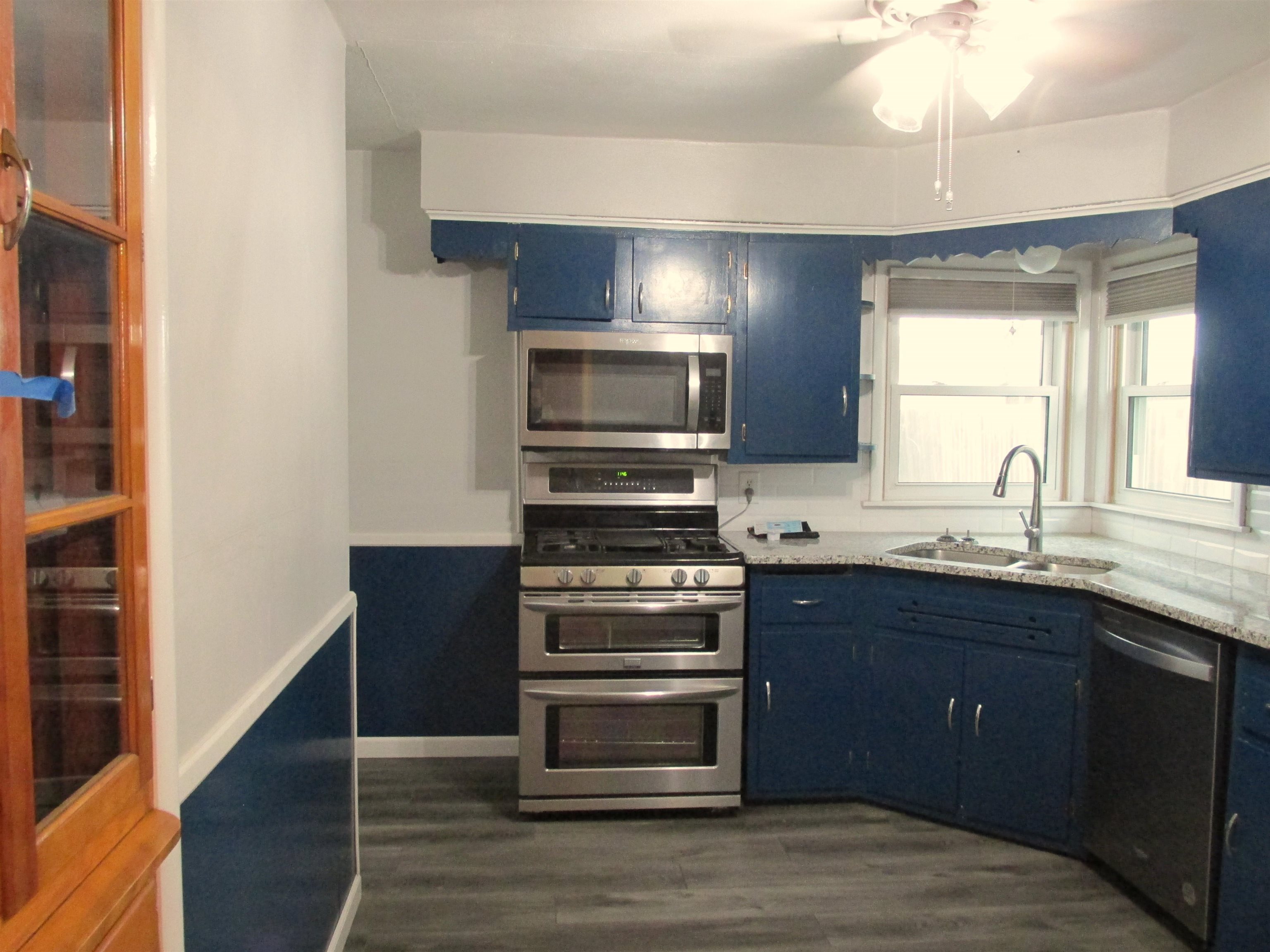 926 West 2nd Street Byron, IL 61010 - Photo 4 of 20 a kitchen with stainless steel appliances granite countertop a stove and a sink
