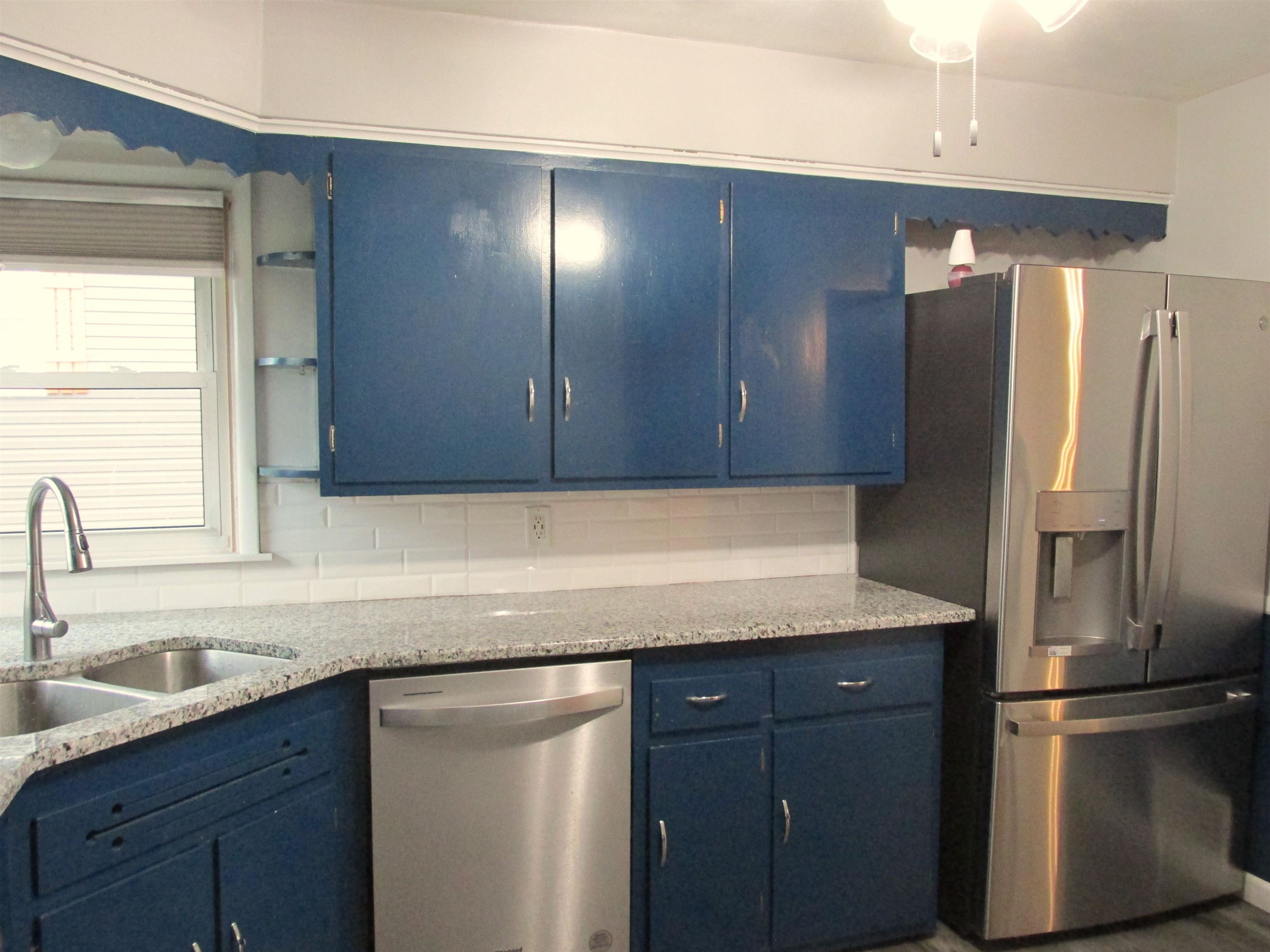 926 West 2nd Street Byron, IL 61010 - Photo 5 of 20 a kitchen with a sink and refrigerator