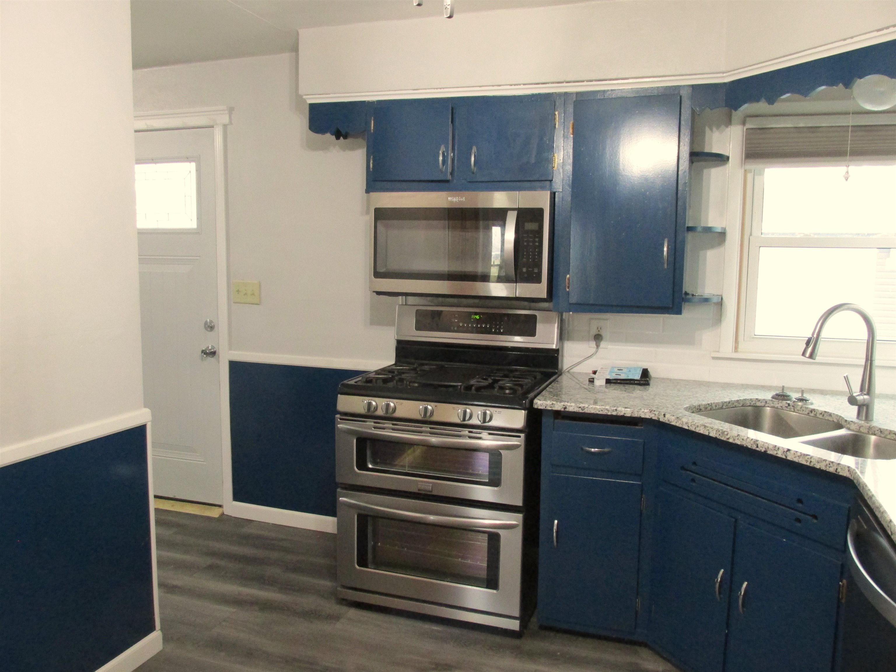 926 West 2nd Street Byron, IL 61010 - Photo 6 of 20 a kitchen with a sink stove and microwave