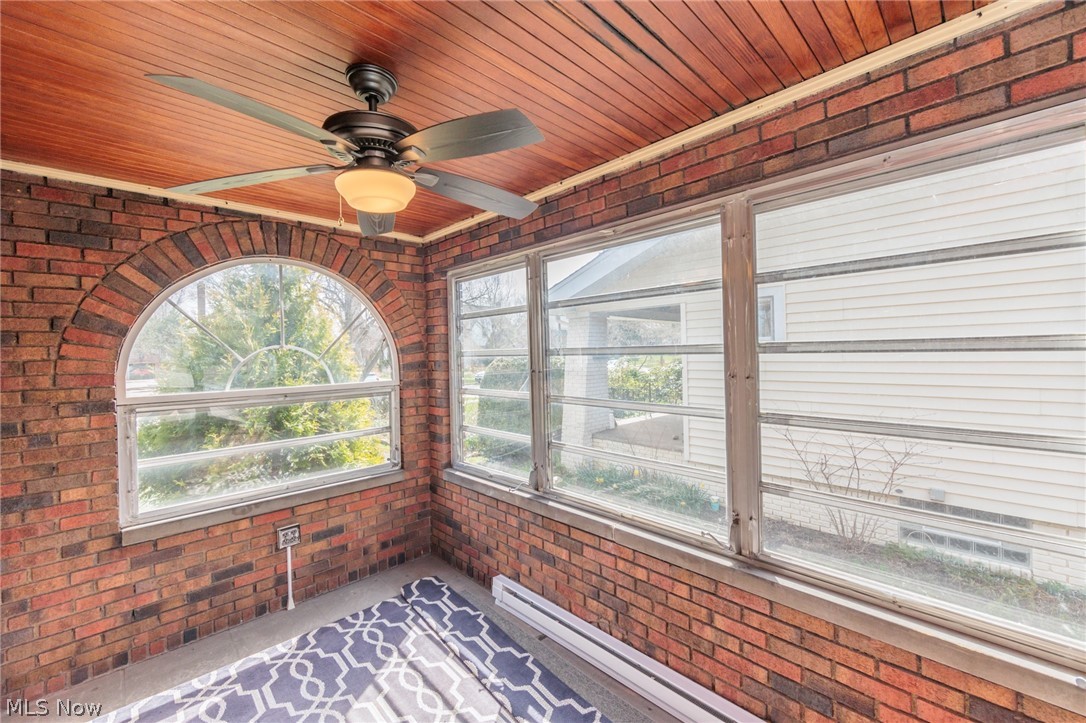 2472 Eaton Road Cleveland, OH 44118 - Photo 13 of 50 Unfurnished sunroom featuring ceiling fan, wood ceiling, and a healthy amount of sunlight