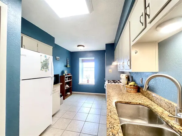 a kitchen with a refrigerator and a sink