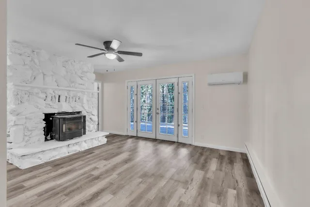 wooden floor fireplace and natural light in room