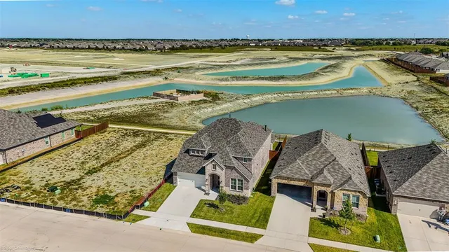 an aerial view of a house with a ocean view